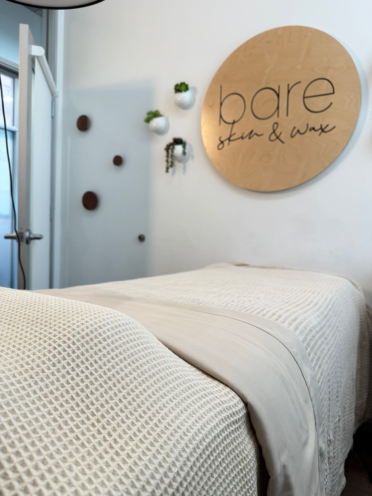 Cozy facial and waxing bed under the Bare Skin & Wax sign in our Woodland Hills studio
