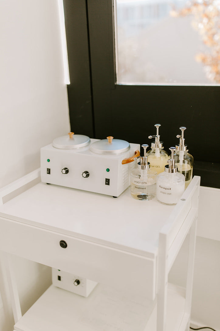 Professional wax warmers and pre- and post-wax oils at Bare Skin & Wax in Woodland Hills